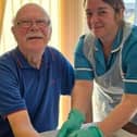 Patient, Paul Barker, has his antibiotic administered at home by nurse associate, Lauren Chester.