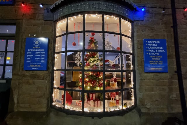White Rose Carpets' Christmas tree in their shop window looking beautiful.