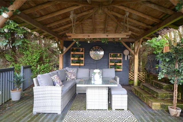 A covered seating area in the garden.