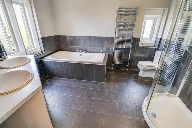 A modern bathroom with twin wash basins and vanity units.