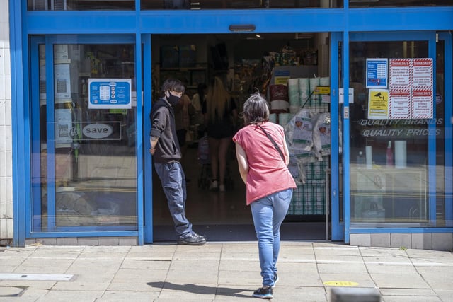 Social distancing measures were still in place as a woman enters a Dewsbury store which reopened after being ordered to close in late March 2020. Picture: Scott Merrylees