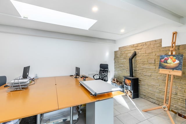 Apart from the main house is a versatile room, ideal as a home office or leisure suite. With an exposed stone wall, a wood burning stove, and a glass lantern ceiling, it has a separate cloakroom and French doors with garden views.