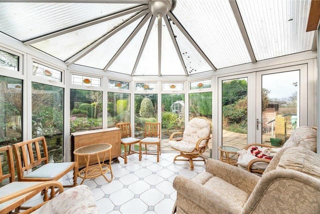The conservatory is surrounded by lovely views of the garden.