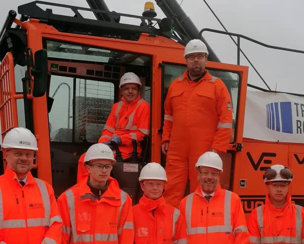 Rail Minister Huw Merriman, TRU managing director Neil Holm and Dewsbury MP Mark Eastwood with apprentices from the project's site in Ravensthorpe