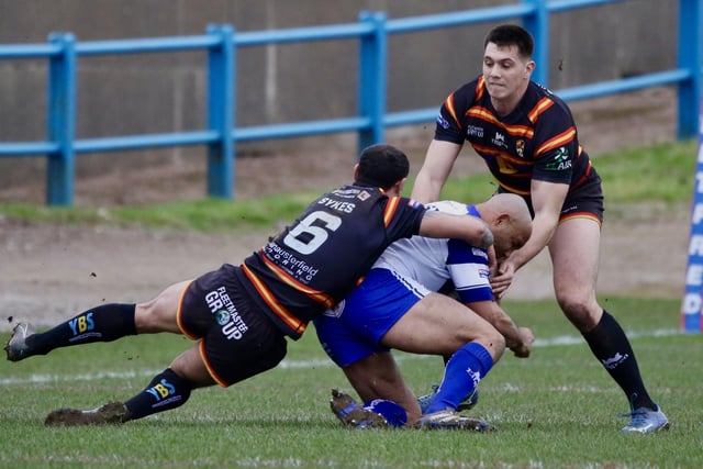 Paul Sykes makes his tackle count to bring down a Workington player.