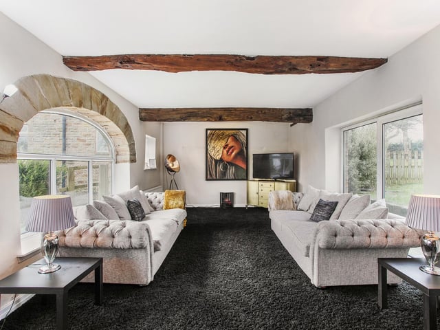 Wooden beams and a stone arch to the window add character to this room.
