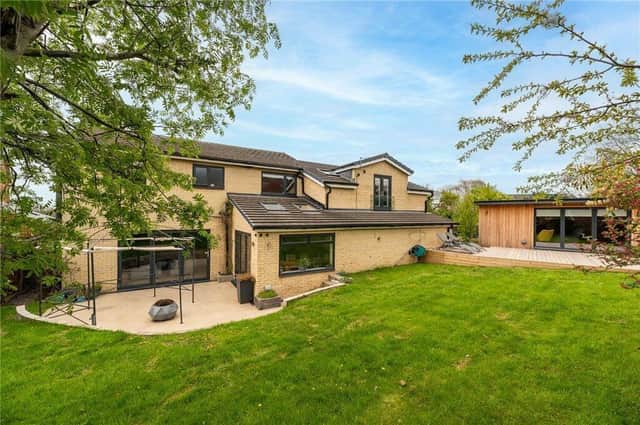 This five-bedroom family home has an enclosed garden with seating areas and summer house.