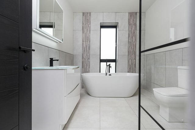 The family bathroom has a large, free standing bath as its centrepiece.