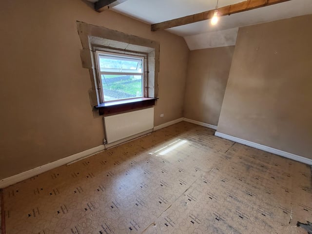 A beamed bedroom within the Northowram property.