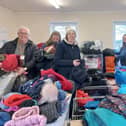 Uniform Exchange founder Kate France (third right) and volunteers sorting out winter coats for Kirklees schoolchildren