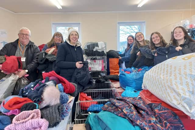 Uniform Exchange founder Kate France (third right) and volunteers sorting out winter coats for Kirklees schoolchildren