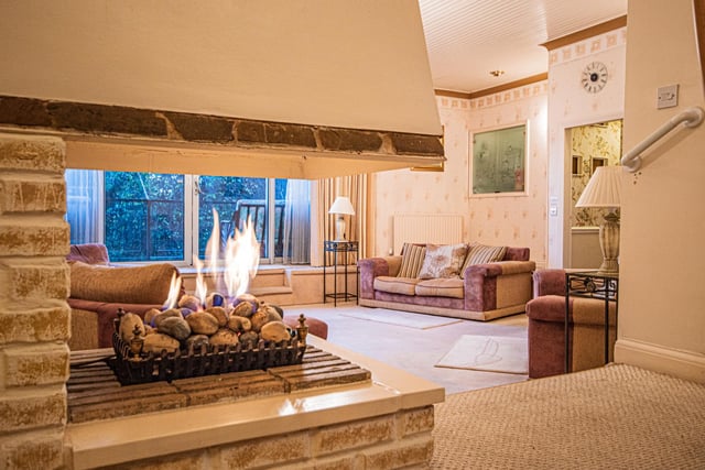 A stone fire feature serves both the dining room and the lounge.