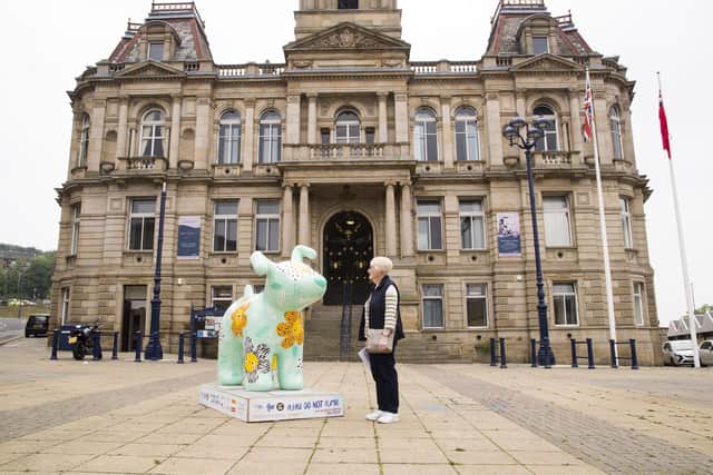 Brenda Craven with the Snowdog outside Dewsbury Town hall.
