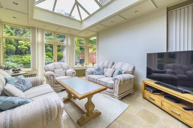 The sun room, with underfloor heating, has doors out to the gardens.