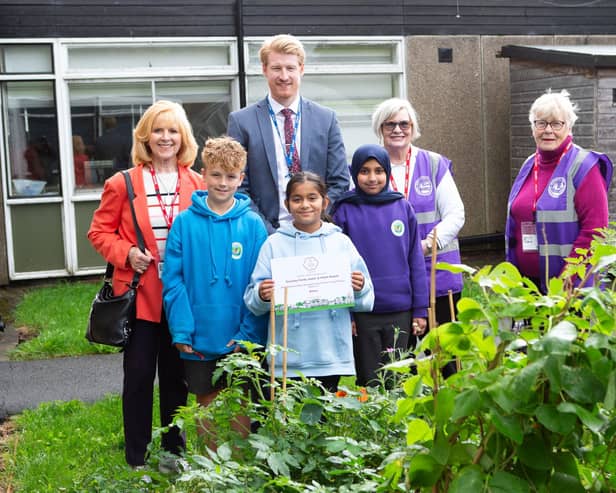 Mirfield In Bloom presenting an award to Crossley Fields Junior and Infant School who have won a Yorkshire In Bloom award. Pictured are back, left to right, Joy Smith of Yorkshire In Bloom, Michael Foster, teacher at Crossley Fields and Ruth Edwards and Christine Sykes of Mirfield In Bloom. Front are pupils Theo Everett, Ayesha Master and Zainab Hussain.