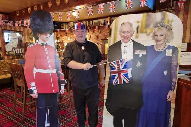 Tim Wood with the lifesize cardboard cutouts of King Charles III and the Queen Consort at the Old Colonial.