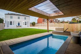 The heated pool with bar is a luxurious feature with this family home in Ossett.