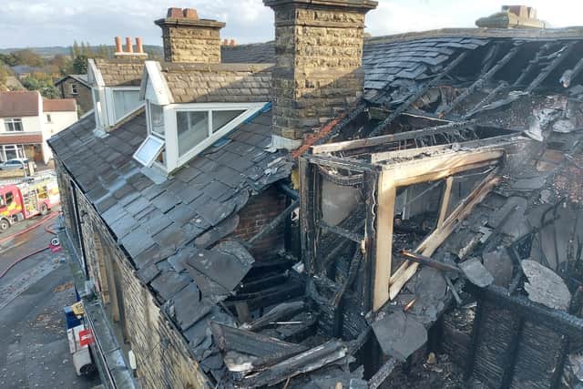 A picture of the damaged building after fire erupted in a flat above shops at The Knowl, Mirfield, on Wednesday October 26.