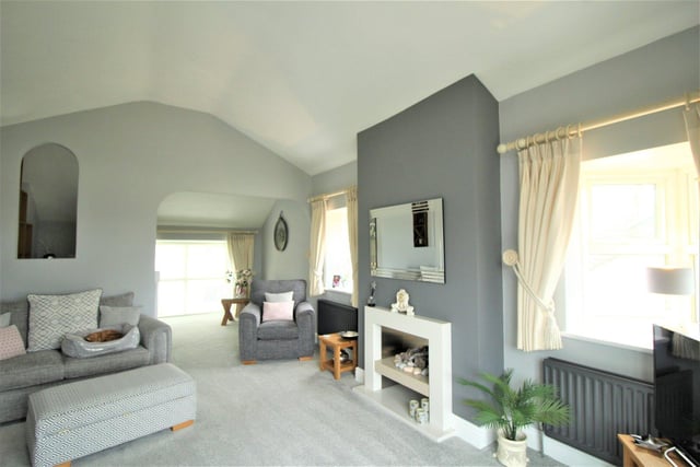 The spacious sitting room has a feature fireplace and walk-in bay window.
