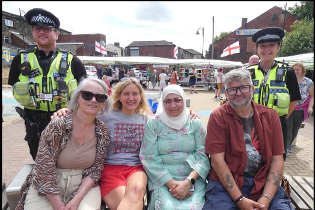 Spen Valley MP, Kim Leadbeater, enjoying the atmosphere with Simon Thirkhill (right). The market stalls at the busy New Square can be seen in the background.