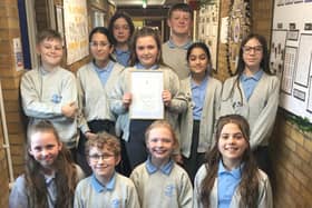 Pupils at St Paulinus Catholic Primary Academy in Dewsbury with the framed letter from Queen Camilla. Pictured on the back row, left to right, are Theo, Zara, Gabby, Eva, Riley, Fatima and Izzy. On the front row from the left are Layla, Eli, Lyla and Nevaeh