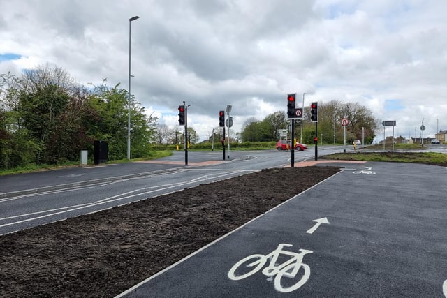 There is now a tarmacked area - for pedestrians and cyclists - in between the carriageways on Halifax Road connecting two controlled crossings.
