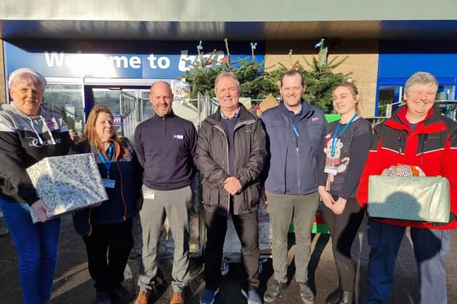 Tina Hardy, far left, Trevor Best, centre, and Caroline Holt, far right, are joined by staff at B&M Store Batley, including store manager Richard Garside, third from left, and deputy manager Holly Tyson, second from right, who helped put the hampers together.