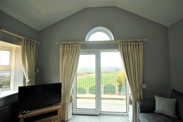Double doors lead from the lounge to a balcony with rewarding views.