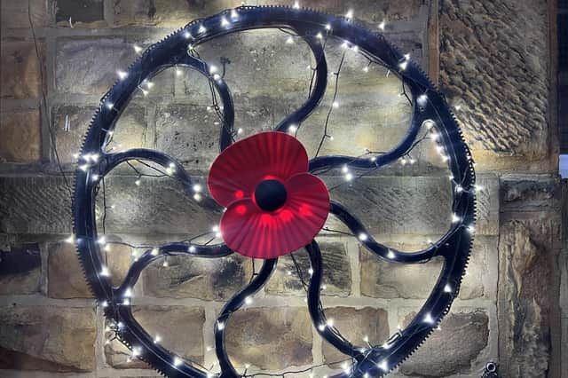 Owner of family-run Nelsons Birstall Ltd, Alistair Hartley, has been adorning the cast iron wheel, which is mounted on the front wall of their Gelderd Road site, with the poppy since last year.