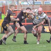 Dale Ferguson tried to evade the clutches of three determined - and "tough" according to Dewsbury Rams' head coach Liam Finn - Ashton Bears players.