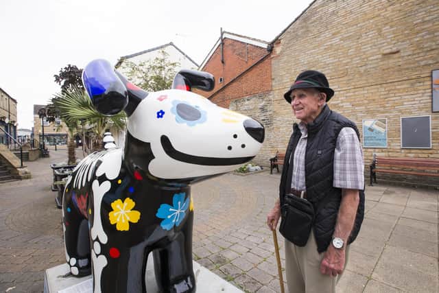 Flashback: Visitor Michael Burton admires the Kirkwood's  ‘Day of the Dog' sculpture in Cleckheaton before it was vandalised.