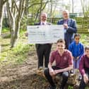 From left: Headteacher of Ravenshall School, Rik Robinson, receives a cheque for £5,000 from John Hudson from St John's Masonic Lodge, with students Daniel Jackson, 15, Aliyah Shah, seven, and Joshua Platts, 13.
