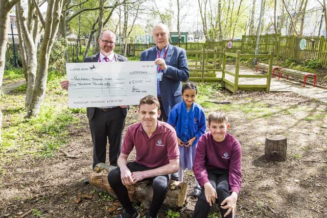 From left: Headteacher of Ravenshall School, Rik Robinson, receives a cheque for £5,000 from John Hudson from St John's Masonic Lodge, with students Daniel Jackson, 15, Aliyah Shah, seven, and Joshua Platts, 13.