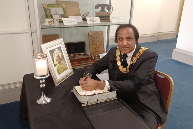 The Mayor of Kirklees, Coun Masood Ahmed signing the book of condolence at Dewsbury Town Hall.