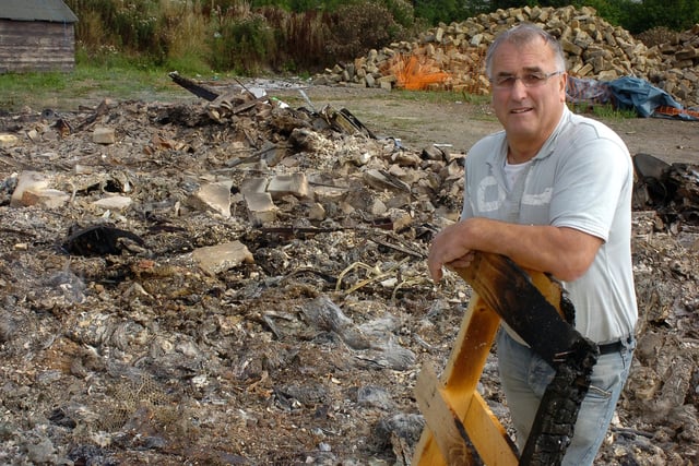 Howard Cook at the burnt site at Ponderosa in 2009 after someone had set alight a pile of wood that was for bonfire night. Ponderosa had been collecting the wood all year for the community bonfire, meaning they had to start again from scratch.