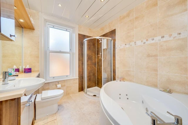 The main bathroom includes a jacuzzi style bath within its suite.