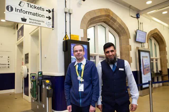 Relieved and happy staff at Dewsbury Train Station after it was announced that plans to close ticket offices around England had been scrapped. Pictured are customer support supervisors Chris Blackburn and Ilyas Hans.