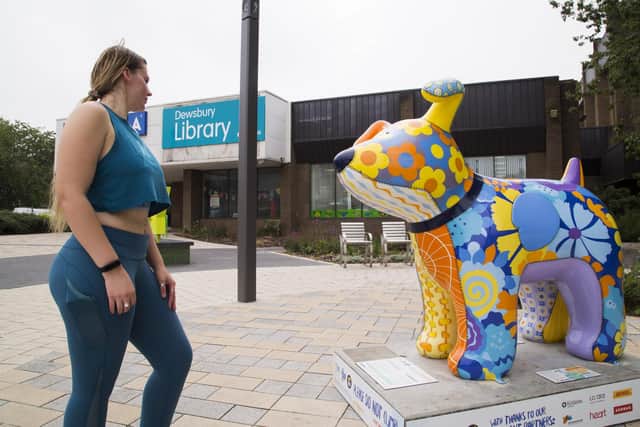 Rebecca Bishop with the Snowdog outside Dewsbury Library.
