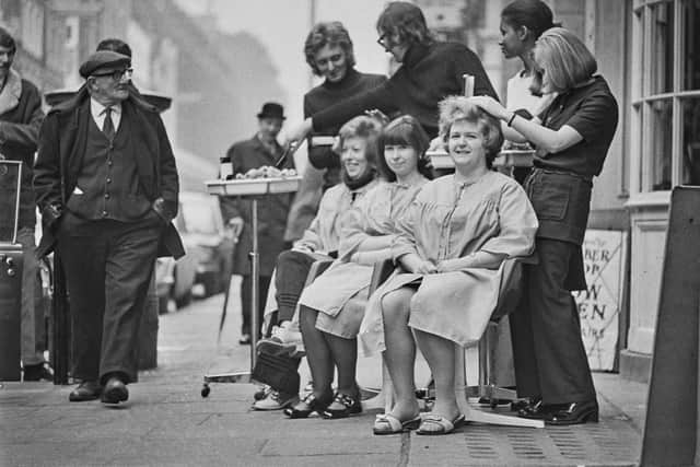 1972: Hair cuts on the pavement due to power cuts. Photo: Getty Images