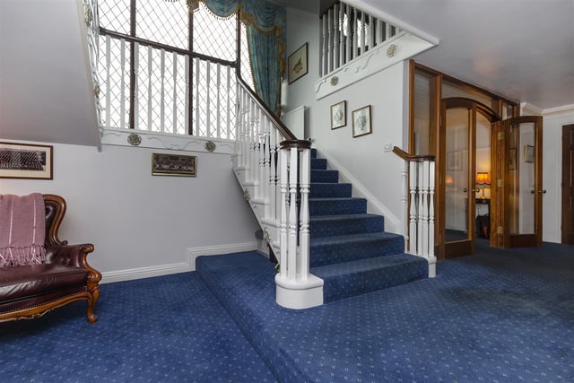 A spacious entrance hall with staircase leading up.