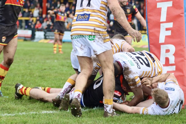 Ronan Dixon goes over for the first try of the game to put Dewsbury in front.