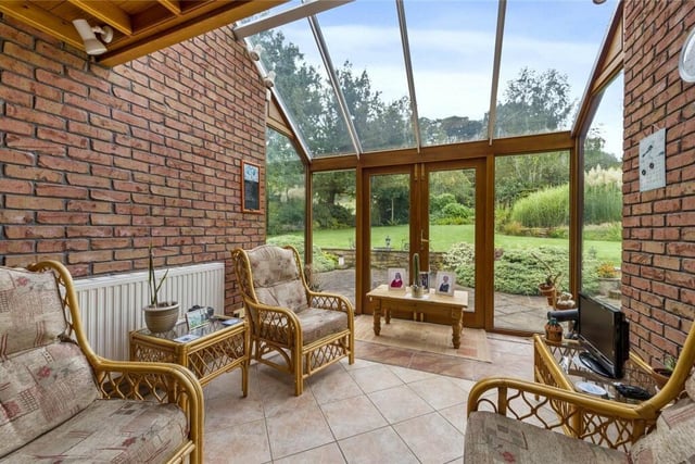 The sun room is a relaxing space with views across the attractive garden.