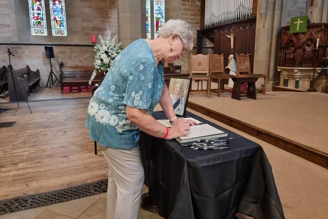 Cathryn Riley signing the book of condolence at Dewsbury Town Hall.