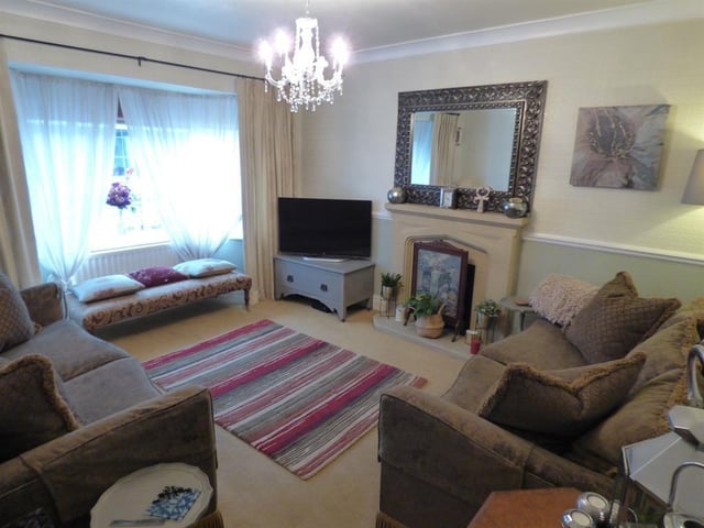 A bay window and fireplace are features of this reception room.