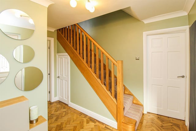 The entrance hall has reclaimed parquet flooring and a solid oak staircase.