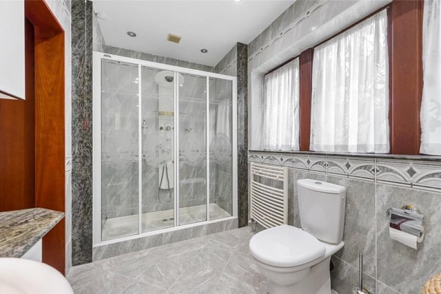 This same bathroom, that is one of three within the property, also features a walk-in shower unit.