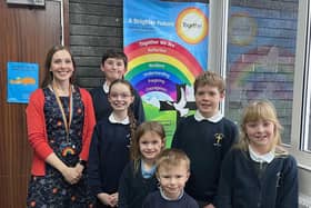 Lesley Evans, headteacher at St Peter’s C of E (VA) Junior, Infant and Early Years School in Birstall, celebrates the school's latest Ofsted report with pupils.
