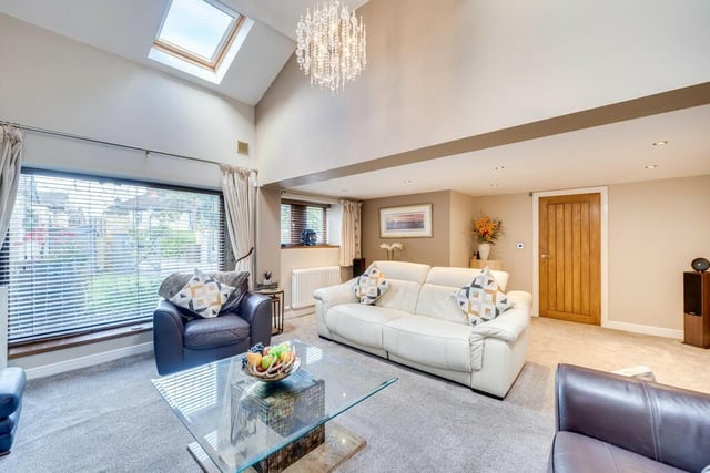 Natural light floods in to the lounge with its many windows and part-vaulted ceiling.