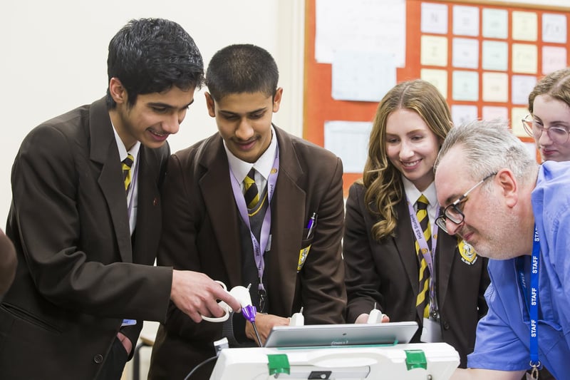 From the left, students Rehan Lohn, Omar Kadarsha and Kate Moulton, with Dean Harness from the NHS.