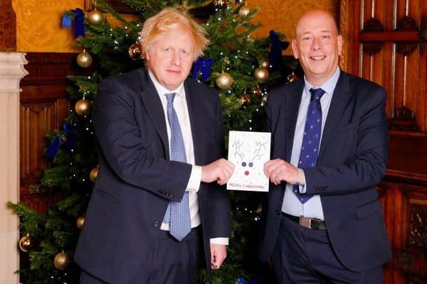 Mark Eastwood presenting last year's winning Christmas card to the then prime minister Boris Johnson.